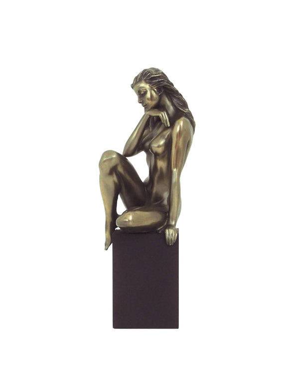 Nude of woman thoughtful on cube