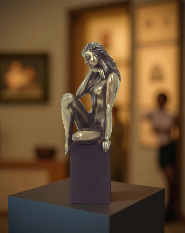 Nude of woman thoughtful on cube