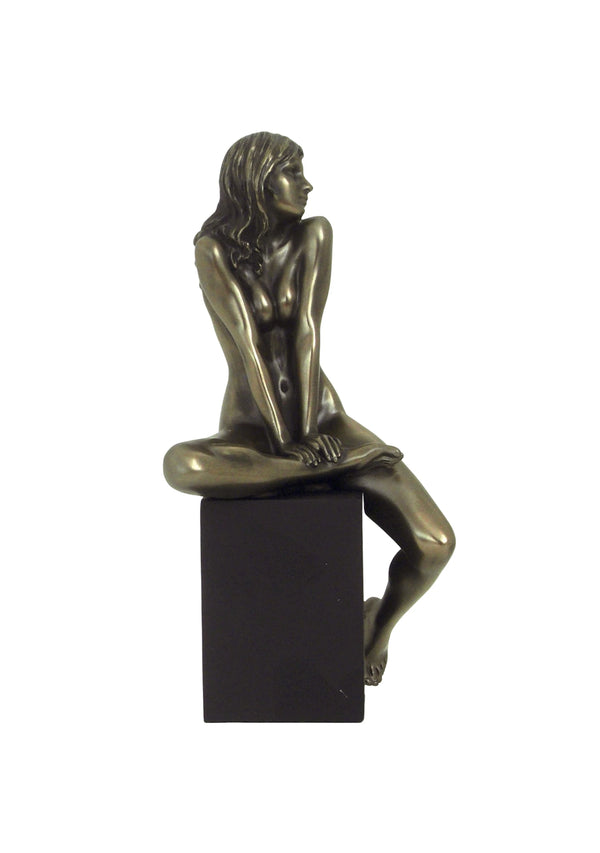 Nude of woman relaxed on cube