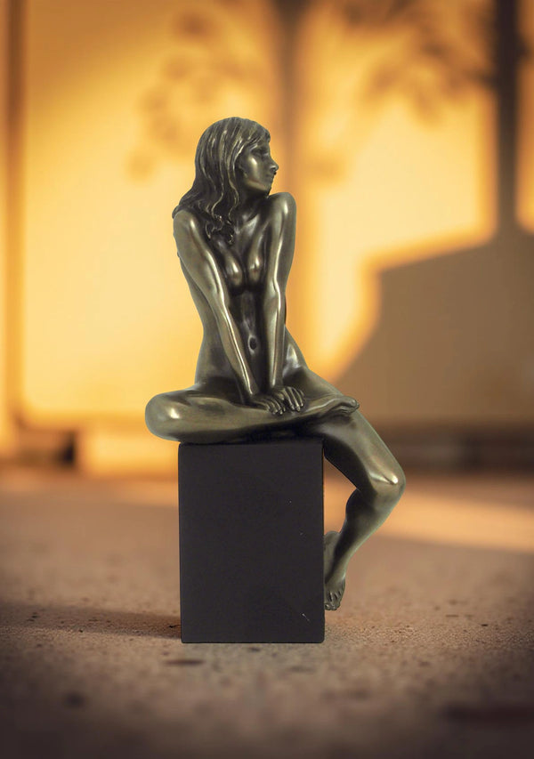 Nude of woman relaxed on cube